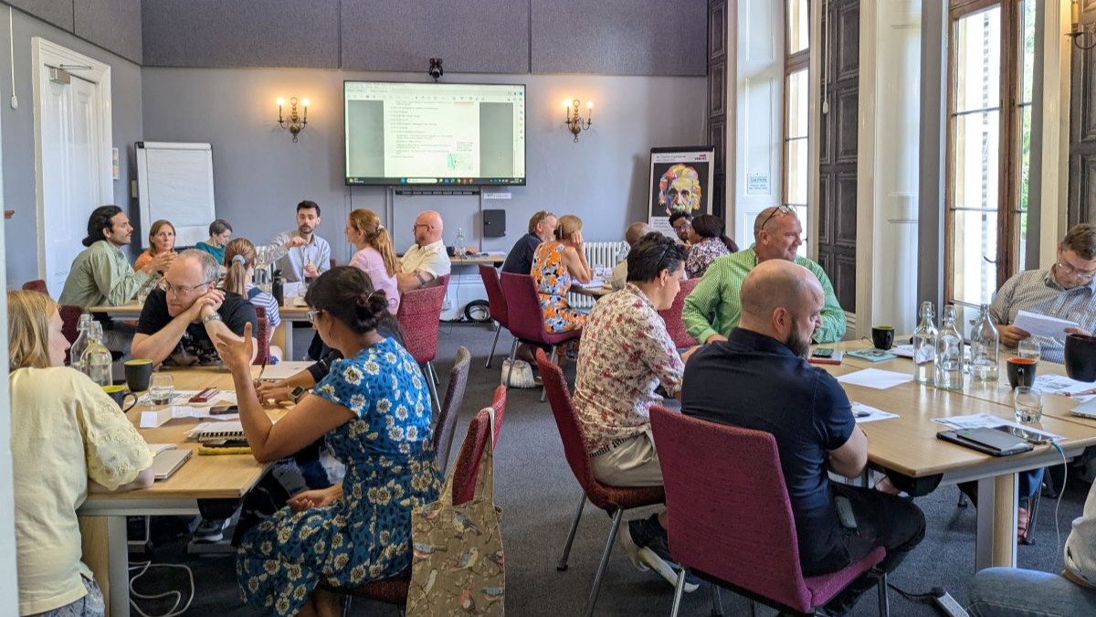 A grand room with seated academics in discussion at tables at UWE Bristol Law School away day
