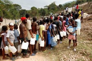Haitians queue for water in Carrefour-Feuilles Slum