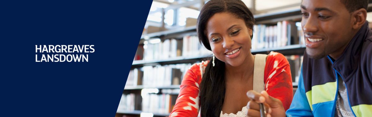 Picture of two Black students looking at a book`