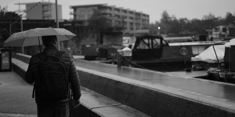Man walking under umbrella