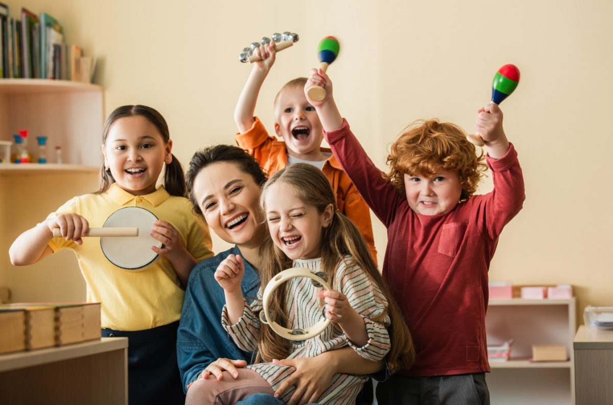Children playing with instruments with their teacher