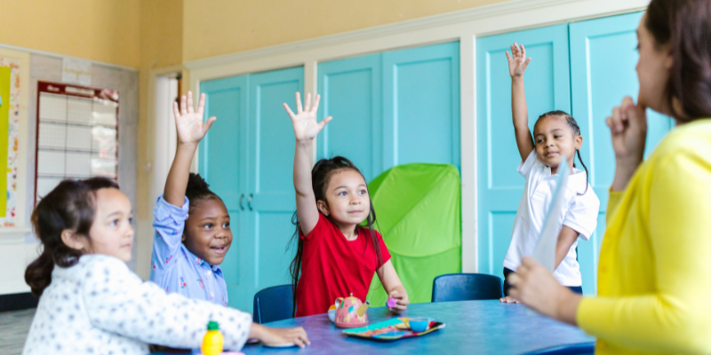 Children with hands raised