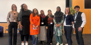 Eight of the event speakers at the Health Inequalities conference, smiling at the camera.