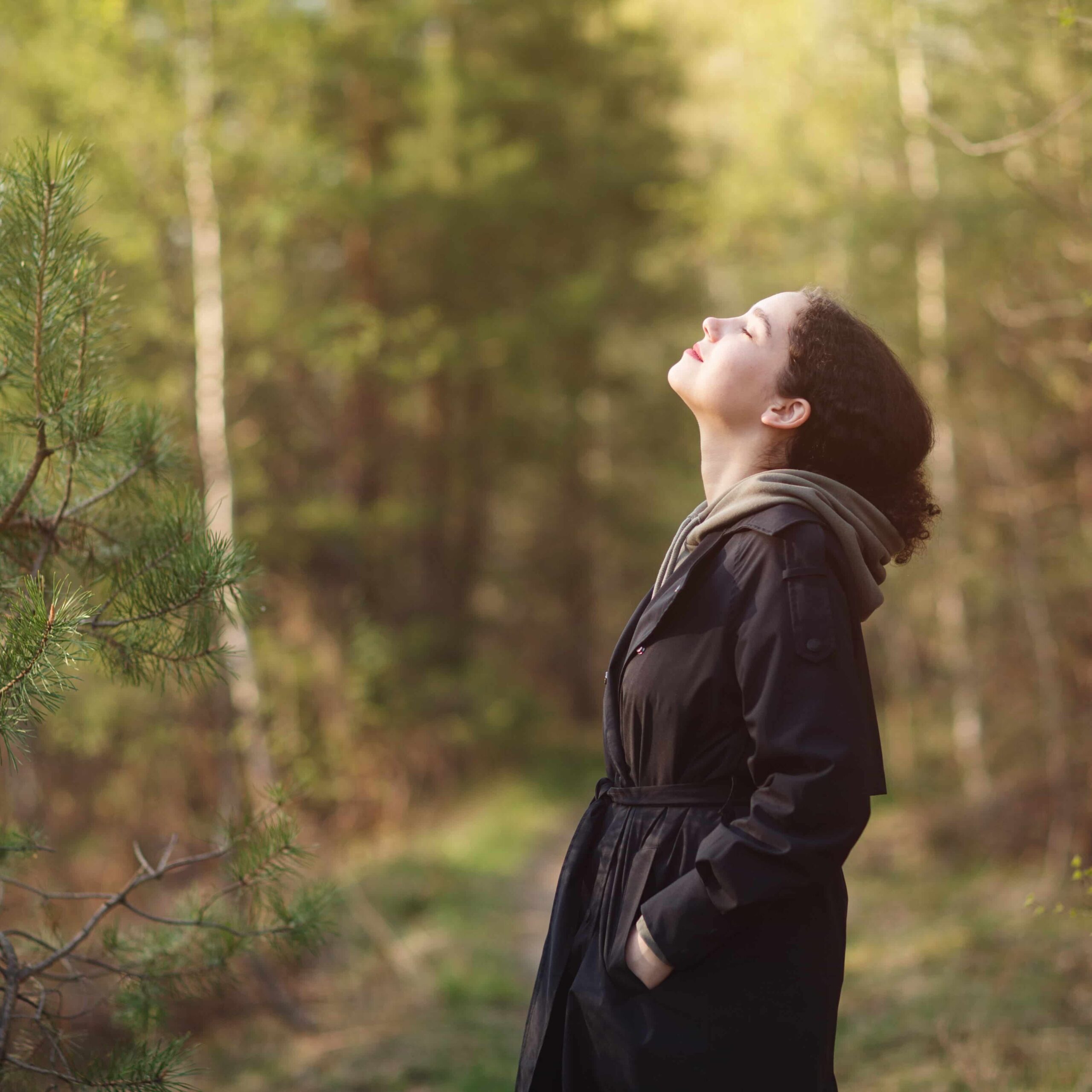 Woman walking in nature park forest and breathing fresh air